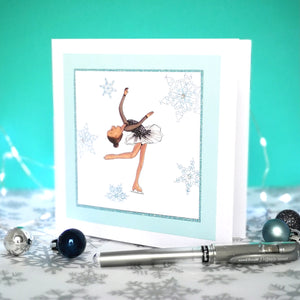 6 x 6 inch greeting card with image of a figure skater in a black dress, surrounded by blue foiled ornate snowflakes