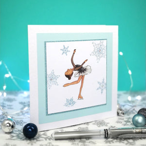 6 x 6 inch greeting card with image of a figure skater in a black dress, surrounded by blue foiled ornate snowflakes