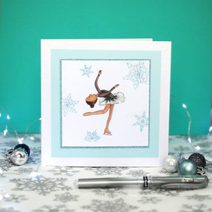 6 x 6 inch greeting card with image of a figure skater in a black dress, surrounded by blue foiled ornate snowflakes