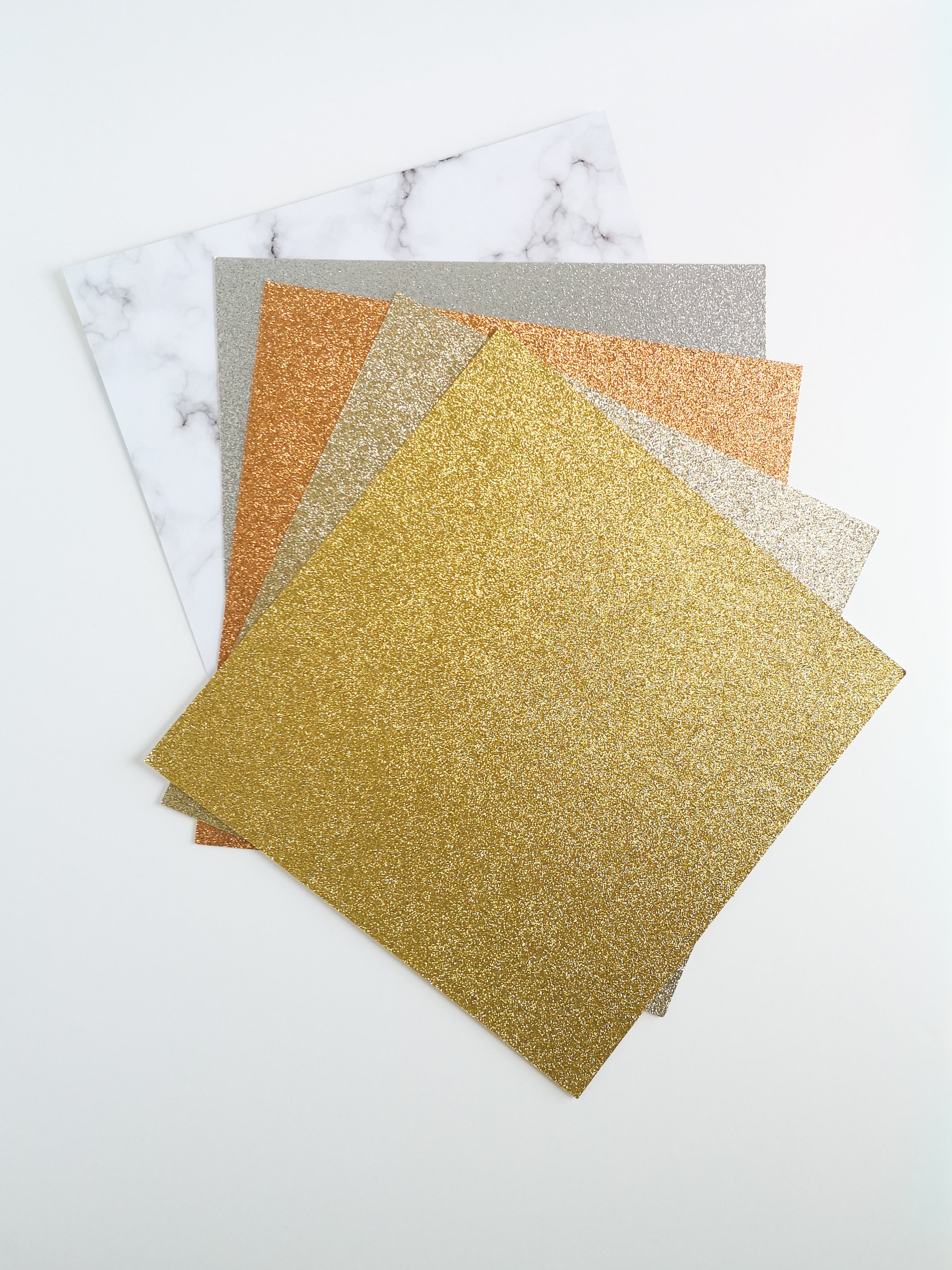 Stack of gold, champagne gold, rose gold copper, & silver glitter 12 x 12 inch recycled cardstock