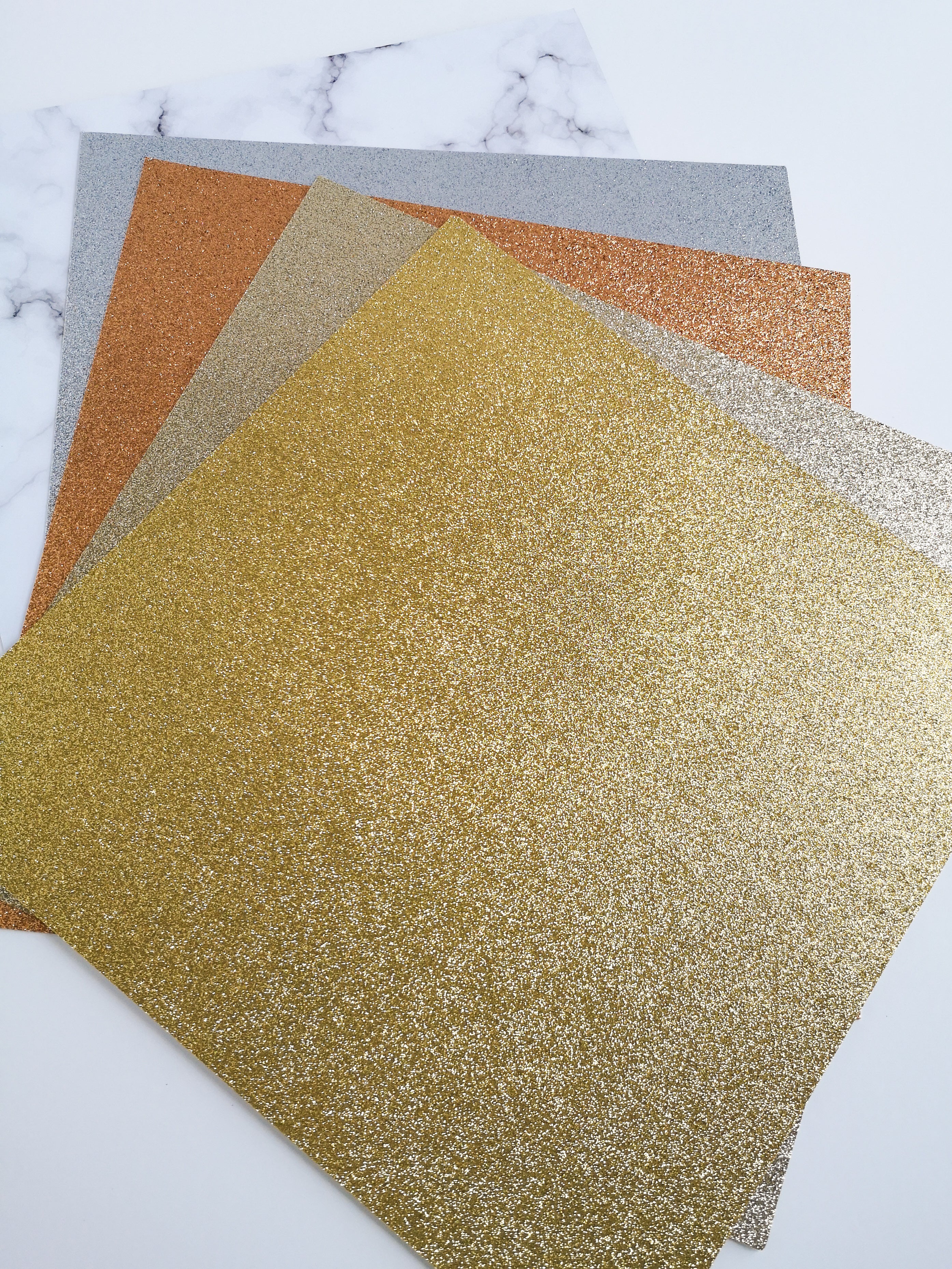 Stack of gold, champagne gold, rose gold copper, & silver glitter 12 x 12 inch recycled cardstock